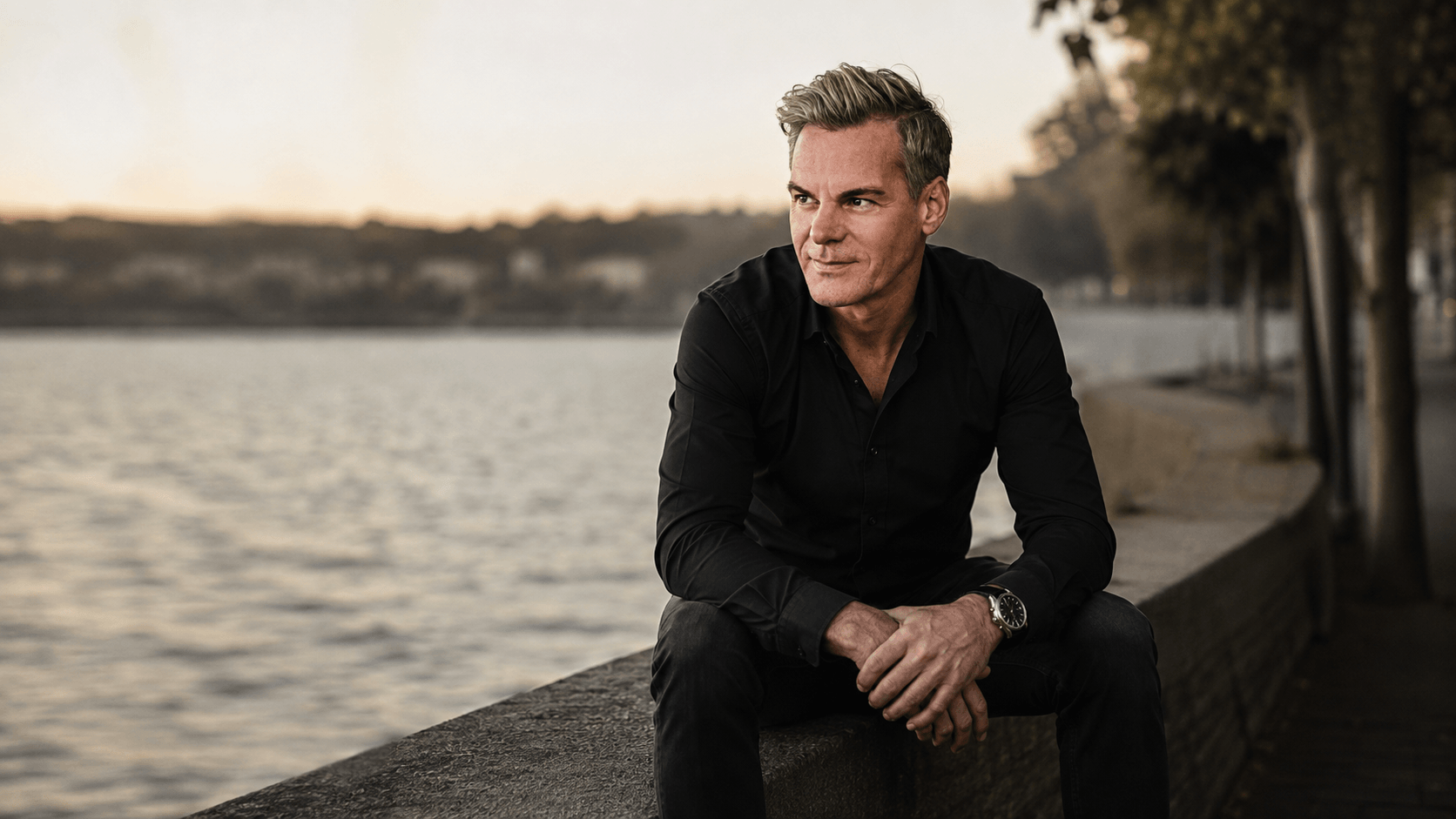 Jörn Boysen, Marketingberater aus München und Gründer von Boysen & Brands, sitzt entspannt am Wasser.